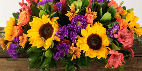 yellow flowers and purple flowers in a fall arrangement